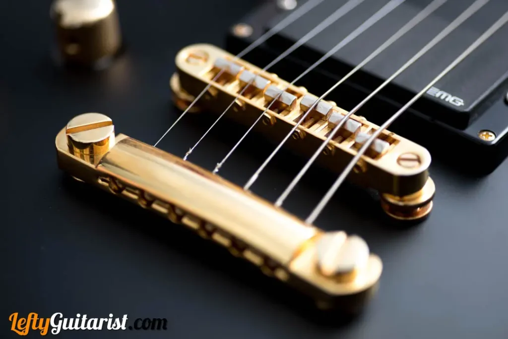 A left handed ESP LTD EC-1000 in Vintage Black finish. It has a gold TonePros locking tune-o-matic bridge.