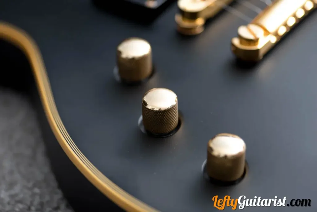 A left handed ESP LTD EC-1000 in Vintage Black finish. It has gold control knobs; 2x volume and 1x tone.
