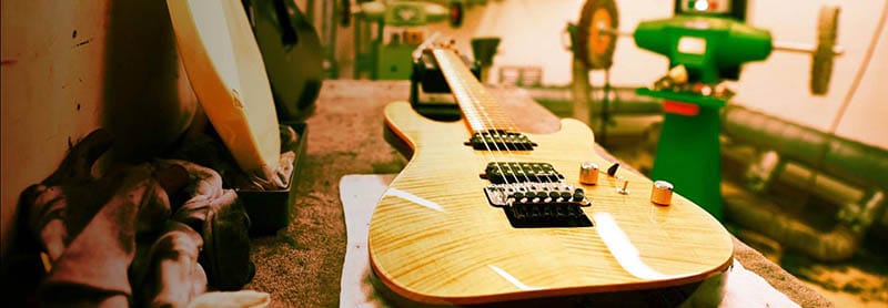 Image of a Harley Benton Fusion II HH guitar laid down on a workbench