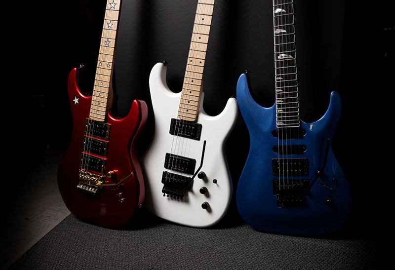 Three Kramer guitars; a Candy Apple Red Jersey Star, a Pearl White Pacer, and a Candy Blue SM-1