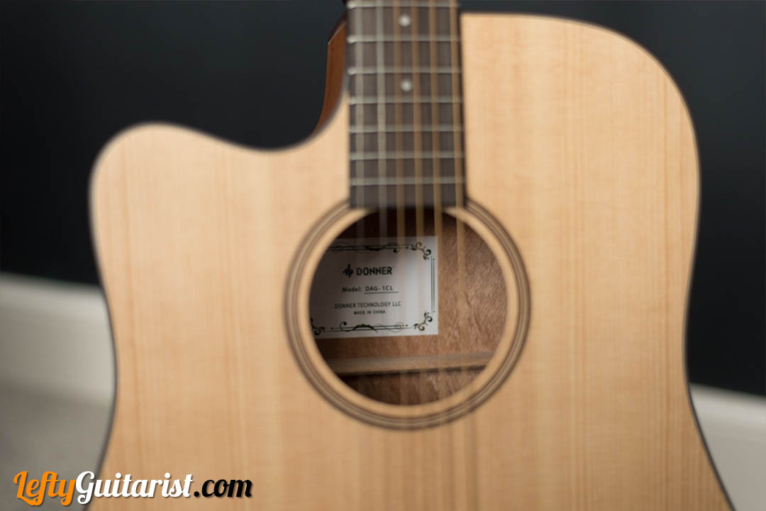 The soundhole of the Donner DAG-1CL acoustic guitar