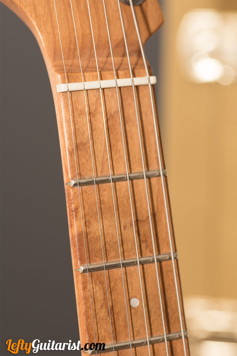 Closeup of the caramelized maple neck of a left handed Charvel Pro-Mod DK24 HH 2PT CM