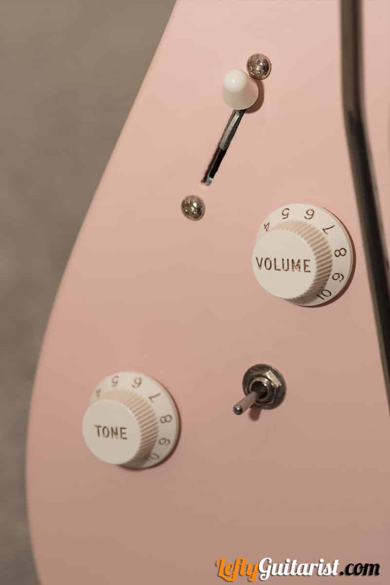Closeup of a left handed Charvel DK24 HH 2PT CM's Series/Parallel switch, Volume and Tone knobs, and 5-way pickup selecter